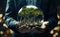 Businessman hands holding a glass sphere with small city and green tree inside save planet