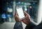 Businessman hands holding phone with white screen template in modern office. Closeup businessperson reading text message