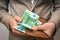 Businessman hands holding wallet with stack of money