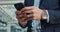 Businessman, hands and phone typing for communication, social media or outdoor networking in city. Closeup of man or