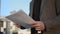 Businessman hands reading documents on street. Male manager keeping papers