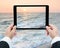 Businessman hands tablet taking pictures beach and sea