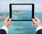 Businessman hands tablet taking pictures beach and sea