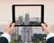 Businessman hands tablet taking pictures buildings under construction and cranes