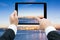 Businessman hands tablet taking pictures Commercial docks at sun