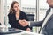 Businessman handshake businesswoman in office.