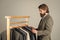 Businessman handsome guy in clothes shop choosing garments, good assortment concept