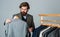 Businessman handsome guy in clothes shop choosing garments, tailored tuxedo concept