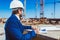 Businessman in hardhat and suit working with building plans