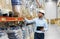 Businessman in helmet with clipboard at warehouse