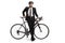 Businessman with a helmet leaning on a bicycle