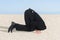 Businessman hiding his head in sand