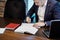 Businessman and his assistant Secretary in his office. The Secretary brought the boss documents to sign,Boss signs the documents