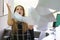 Businessman at his desk throws documents and papers into the air