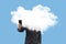 Businessman with his head in the clouds consulting with the mobile the economic crisis on blue background. Surreal concept