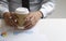 Businessman hold a cup of coffee and reading paperwork