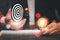 Businessman hold  a darts aiming at the Bullseye is a target in black background - focus on Targeting the business. Business goal