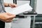 Businessman hold paper for scanning on the office printer