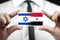 Businessman holding a business card with Israel and Syria Flag