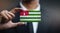 Businessman Holding Card of Abkhazia Flag