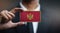 Businessman Holding Card of Montenegro Flag