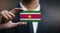 Businessman Holding Card of Suriname Flag