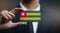 Businessman Holding Card of Togo Flag