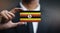 Businessman Holding Card of Uganda Flag