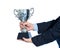 Businessman holding a champion silver trophy on white background