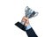 Businessman holding a champion silver trophy on white background