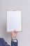 Businessman holding clipboard with blank white paper, empty space for text