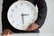 Businessman holding a clock ready to work  Strategy and time management in the office