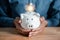 Businessman holding coin into piggy bank with light bulb icon. saving money idea strategy and financial, investment, bank, finance