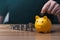 Businessman holding a coin in a piggy bank. money growth and saving money.