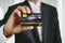 Businessman holding credit card mockup . Plastic bank-card design mock up