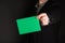 Businessman Holding a Green Card, Empty, Copy Space, Gradient Black.