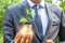 Businessman holding light from sprout, green energy concept.