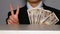 Businessman holding money and posing