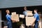 Businessman holding packages near movers and