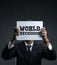 Businessman Holding Paper Covering His Face with  World Recession Text