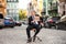 Businessman holding piece of cardboard with word VACANT while sitting in office armchair outdoors