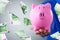 Businessman Holding Piggy Bank and Euro Banknotes Flying