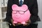 Businessman Holding Piggybank With Eyeglasses