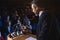 Businessman holding podium speaker in his hand at auditorium