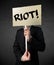 Businessman holding a protest sign