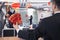 Businessman holding red envelopes and coworkers hanging decorations for Chinese new year