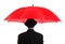 Businessman holding a red umbrella