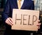 Businessman holding sign Help outdoors