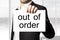 Businessman holding sign out of order burnout