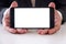 Businessman holding smartphone forward empty white screen for your text or picture